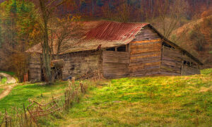 Weathered barn set against a mountainside painted in rich fall colors.